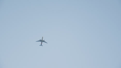 Commercial-Jet-Flying-Overhead-Against-Blue-Sky