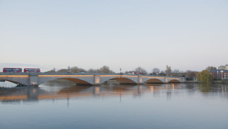 Putney-Bridge-Over-River-Thames-In-London-Illuminated-In-Winter-With-Buses