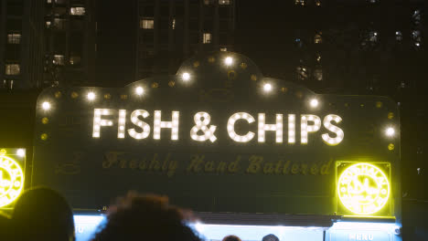 Illuminated-Sign-Above-Fish-And-Chip-Stall-On-London-South-Bank-At-Night-1