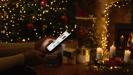 Christmas-At-Home-With-Person-Online-Shopping-on-Mobile-Cell-Phone-1