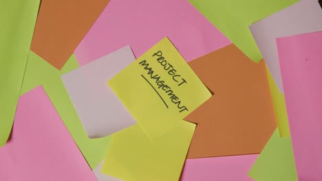 Business-Concept-Of-Revolving-Sticky-Notes-With-Project-Management-Written-On-Top-Note