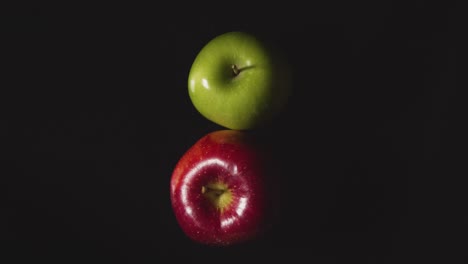 Overhead-Studio-Shot-Of-Red-And-Green-Apples-Revolving-Against-Black-Background-1