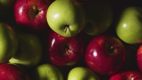 Overhead-Studio-Shot-Of-Red-And-Green-Apples-Revolving-Against-Black-Background-1