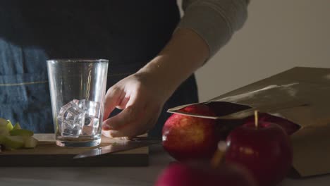 Apple-Juice-Being-Poured-Into-Glass-With-Ice-And-Freshly-Cut-Apples-1