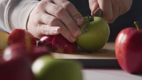 Close-Up-Of-Man-Cutting-Fresh-Apples-On-Chopping-Board-5