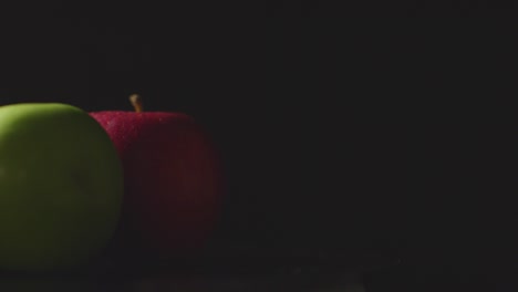 Studio-Shot-Of-Red-And-Green-Apples-Revolving-Against-Black-Background-3