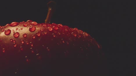 Macro-Studio-Shot-Of-Red-Apple-With-Water-Droplets-Revolving-Against-Black-Background-1