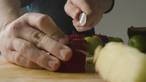 Close-Up-Of-Man-Cutting-Fresh-Apples-On-Chopping-Board-3