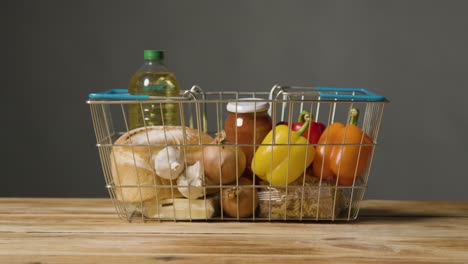 Studio-Shot-Of-Basic-Food-Items-In-Supermarket-Wire-Shopping-Basket-13