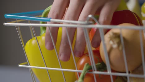 Close-Up-Shot-Of-Person-Taking-Basic-Fresh-Food-Items-From-Supermarket-Shopping-Basket