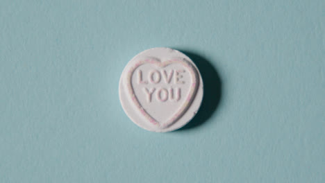 Heart-Candy-With-Love-You-Message-On-Blue-Background