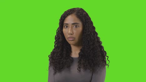Portrait-Of-Sad-Looking-Woman-Against-Green-Screen