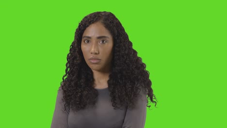 Portrait-Of-Angry-Looking-Woman-Against-Green-Screen
