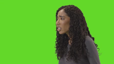 Profile-Shot-Of-Angry-Looking-Woman-Shouting-At-Camera-Against-Green-Screen