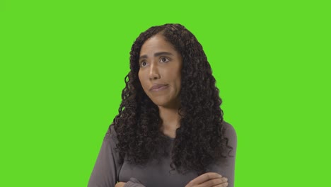 Frustrated-Woman-Looking-At-Mobile-Phone-Against-Green-Screen