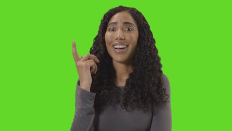 Portrait-Of-Woman-Being-Inspired-By-Good-Idea-Against-Green-Screen-At-Camera
