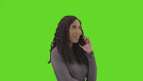 Frustrated-Woman-Talking-On-Mobile-Phone-Against-Green-Screen-Before-Hanging-Up-2
