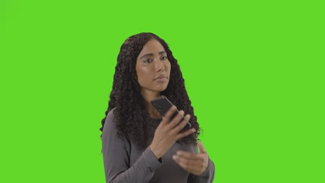 Sad-Woman-Talking-On-Mobile-Phone-Getting-Bad-News-Against-Green-Screen