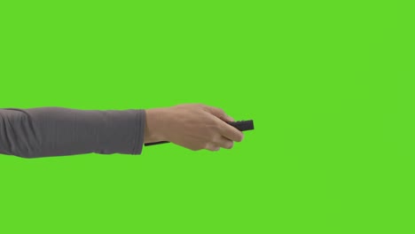 Studio-Close-Up-Shot-Of-Woman-Holding-And-Using-TV-Remote-Control-Against-Green-Screen