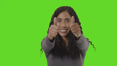 Studio-Portrait-Shot-Of-Woman-Giving-Double-Thumbs-Up-Sign-Against-Green-Screen-2