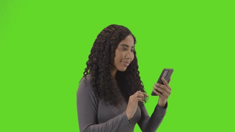 Woman-Looking-At-Mobile-Phone-And-Celebrating-Good-News-Against-Green-Screen-3