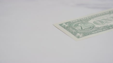 Close-Up-Currency-Shot-Of-Hand-Grabbing-US-1-Dollar-Bill-On-Marble-Background-1