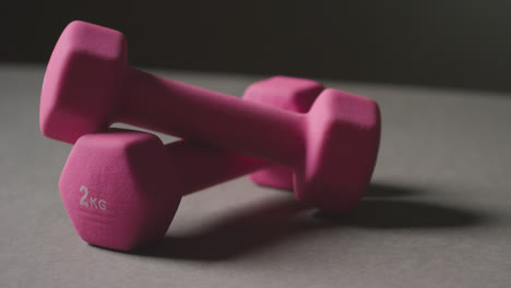 Close-Up-Studio-Fitness-Shot-Of-Pink-Gym-Hand-Weights-On-Grey-Background