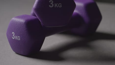 Close-Up-Studio-Fitness-Shot-Of-Purple-Gym-Hand-Weights-On-Grey-Background-1