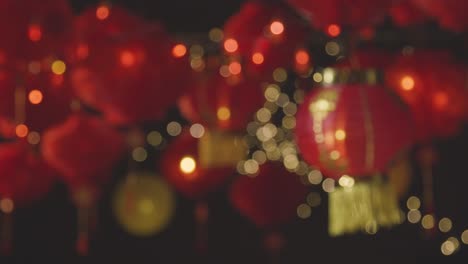 Defocused-Studio-Shot-Of-Colourful-Chinese-Lanterns-Celebrating-New-Year-Hung-Against-Black-Background