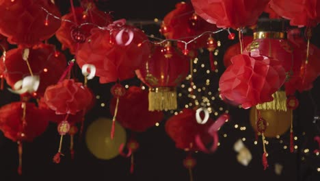 Studio-Shot-Of-Chinese-Lanterns-Celebrating-New-Year-With-Falling-Confetti