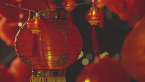 Close-Up-Of-Colourful-Chinese-Lanterns-And-Lights-Celebrating-New-Year-Hung-Against-Black-Background