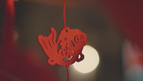 Close-Up-Of-Woman-Touching-Chinese-Decoration-Hanging-From-New-Year-Lantern-