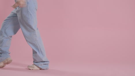 Close-Up-On-Legs-And-Feet-Of-Woman-Having-Fun-Dancing-Against-Pink-Studio-Background-2