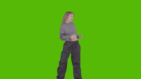 Studio-Shot-Of-Young-Woman-Having-Fun-Dancing-Against-Green-Screen-33