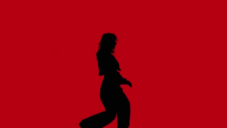 Studio-Silhouette-Of-Woman-Dancing-Against-Red-Background