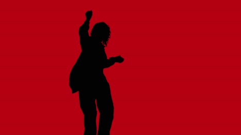 Studio-Silhouette-Of-Woman-Dancing-Against-Changing-Coloured-Backgrounds