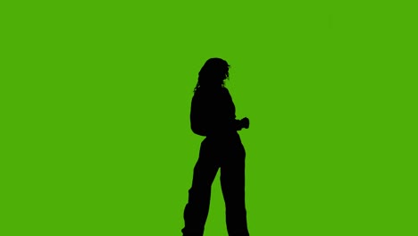Studio-Silhouette-Of-Woman-Dancing-Against-Green-Background-4