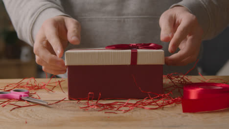 Close-Up-Of-Man-At-Home-Gift-Wrapping-Romantic-Valentines-Present-In-Box-3