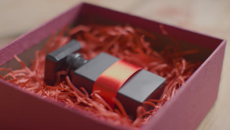 Close-Up-Shot-Of-Romantic-Valentines-Present-Of-Perfume-Gift-Wrapped-In-Box-On-Table-3