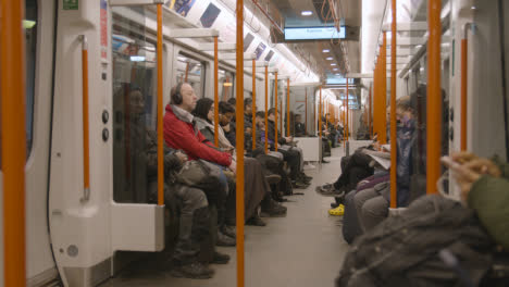 Interior-Shot-Of-Passengers-Commuting-In-Carriage-Of-UK-Train-In-Early-Morning