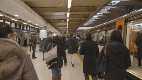 Commuter-Passengers-Getting-Off-UK-Train-At-London-Euston-Station