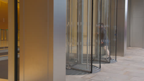 Revolving-Doors-At-Entrance-To-Modern-Office-Building-In-City-Of-London-UK