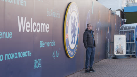 Fan-Posing-Outside-Stamford-Bridge-Stadium-Home-Ground-Chelsea-Football-Club-London-