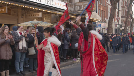 People-With-Parasols-And-Flags-In-Parade-Around-Trafalgar-Square-In-London-UK-In-2023-To-Celebrate-Chinese-New-Year-