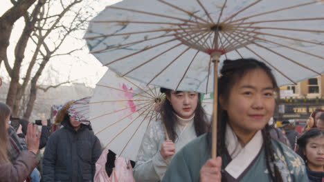 Frauen-Mit-Sonnenschirmen-Bei-Einer-Parade-Um-Den-Trafalgar-Square-In-London-Im-Jahr-2023,-Um-Das-Chinesische-Neujahr-Zu-Feiern
