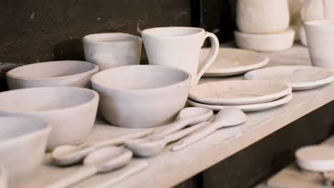 Close-Up-Of-Various-Ceramic-Dishware-On-A-Wooden-Shelf-In-The-Pottery-Shop