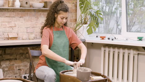 Clerk-Woman-Modeling-Ceramic-Piece-On-A-Potter-Wheel-In-A-Workshop-2