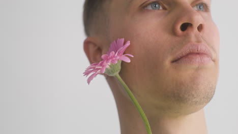 Close-Up-View-Of-Handsome-Man-Holding-Pink-Flower