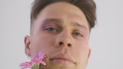 Close-Up-Of-Model-Man-Smiling,-Holding-A-Flower-And-Looking-At-Front