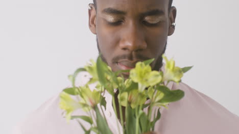 Young-Man-With-Make-Up-Smelling-Flowers
